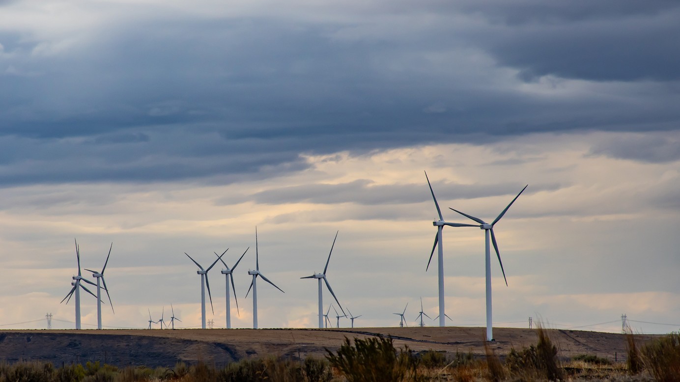 About 20 wind turbines on an open field