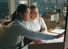 Two woman looking at a screen