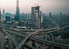 A skyline of a large modern city with a network of highways