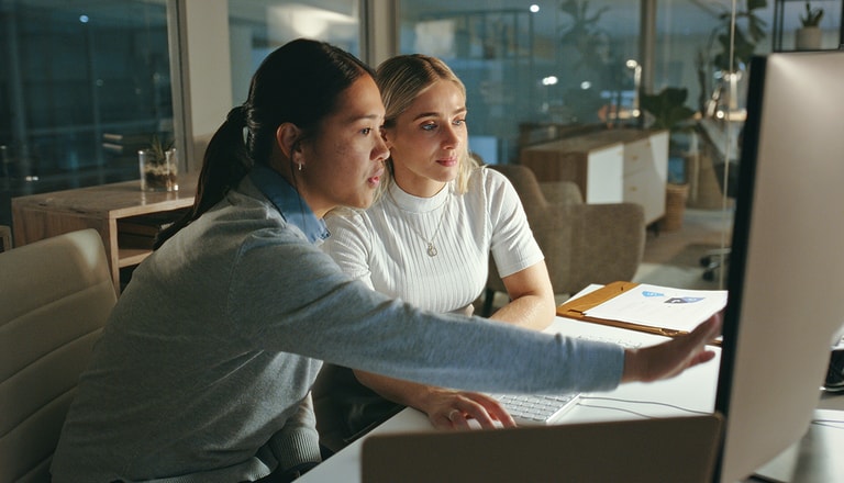 Two woman looking at a screen