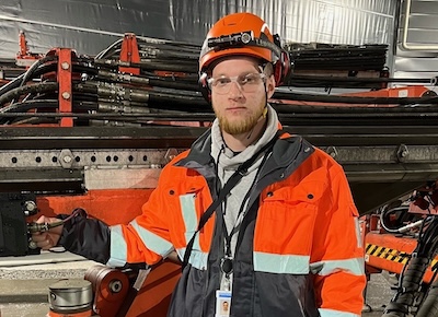 Summerworker Andreas Osara wearing safety clothing in a manufacturing environment