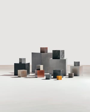 Metal blocks representing materials in an electric car, including iron, copper, zinc, cobalt, aluminum, lithium, and manganese.