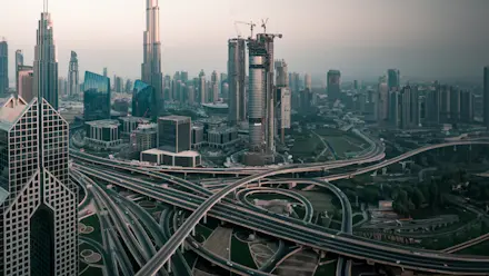 A skyline of a large modern city with a network of highways